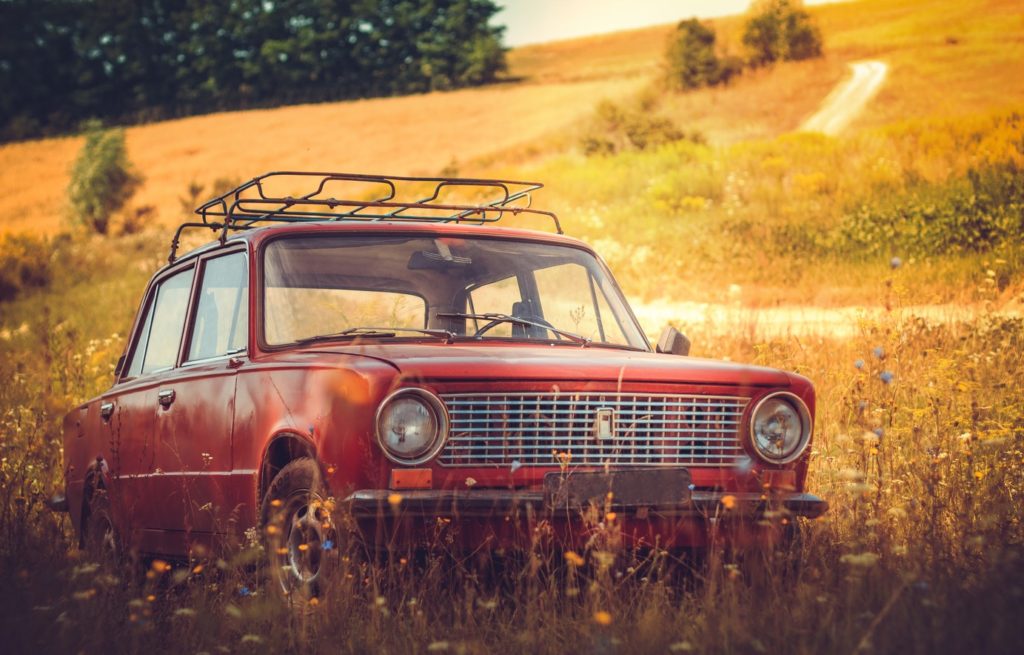 car parked in country field