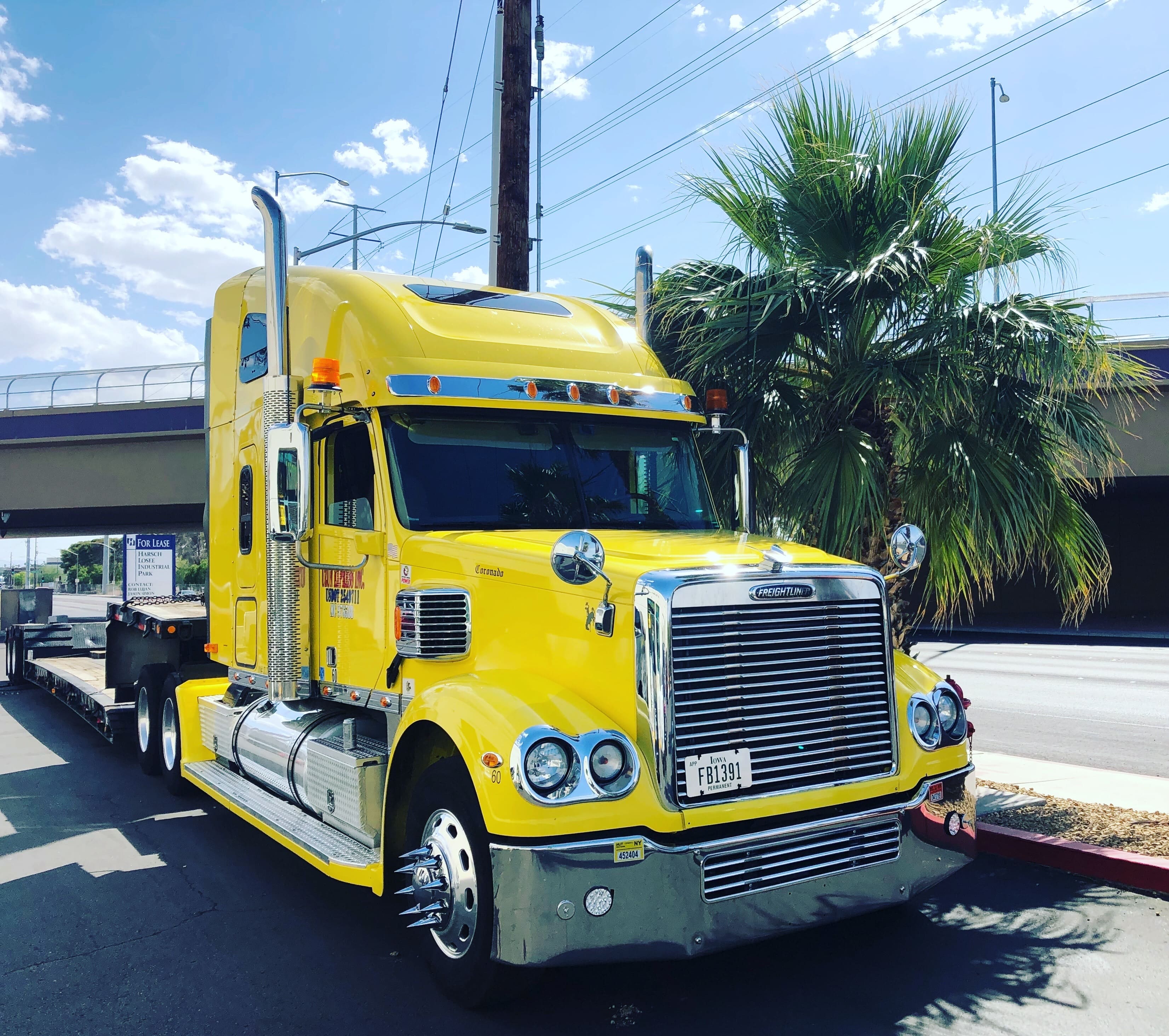 A Yellow Truck parked by the side of the road
