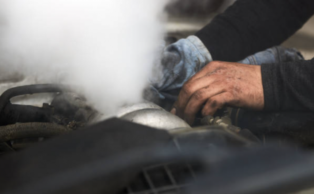 mechanic working on overheated car