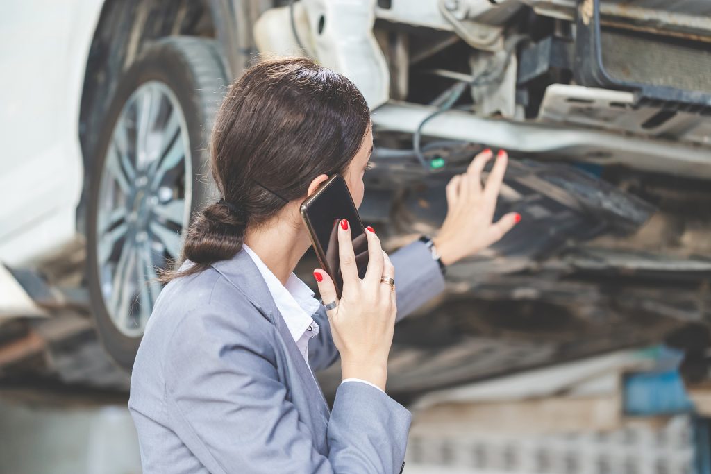 Woman at a car garage getting mechanical service